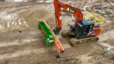 Agetur UK excavator moving SiteStak drainage workstation on a construction site drone photo